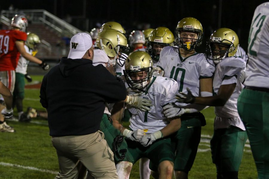 The defense rallies around Grant Henderson '20 following his late-game stop in the fourth-quarter of the Battle for the Boot at Bates Field on Oct. 25.