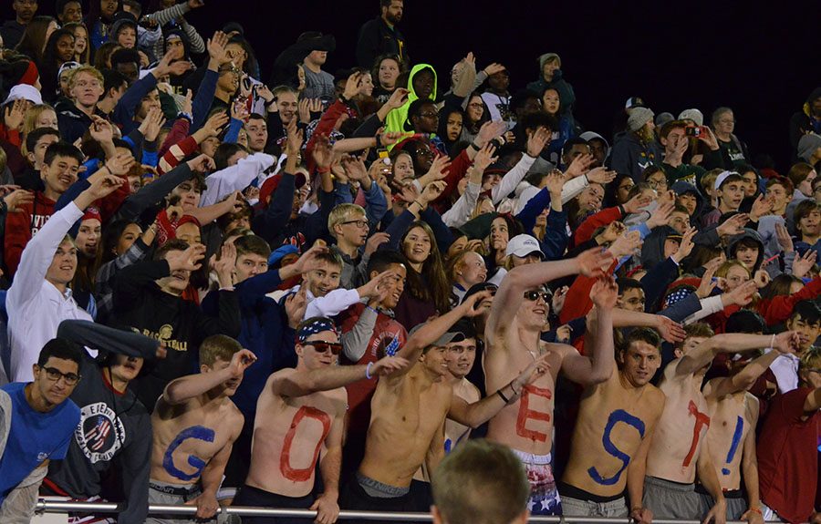 The student section participates in the chant "Lean" directed by the cheerleaders at the Homecoming football game against Linn-Mar on Oct. 4.   