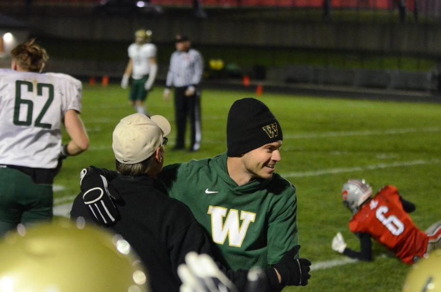 Defensive coordinator Tyler Meade celebrates with linebacker coach Paul Brietbach following the game-sealing interception from Anu Dokun '20 in the Battle for the Boot at Bates Field on Oct. 25.