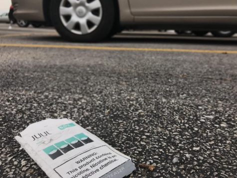 A pack of mint Juul pods sits discarded in the parking lot in front of West. 