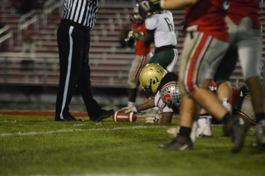 Marchaun Hoover '20 reaches for a first down during a fourth-quarter touchdown drive in the Battle for the Boot at Bates Field on Oct. 25.