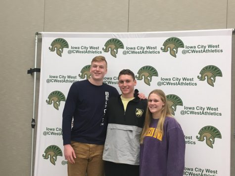 West High senior athletes Even Brauns, James Pinter and Lily Ernst pose for a photo in their schools colors on the fall sports signing day, Nov. 13.