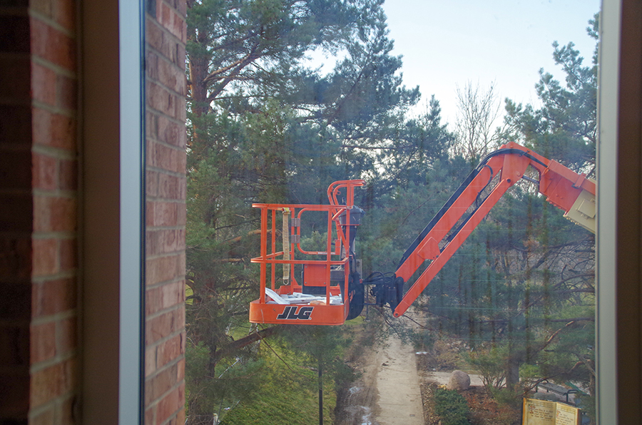 Some air conditioning units still need to be installed. On the morning of Tuesday, Nov. 26 construction workers use a boom lift to finish installing air conditioning units in the new classrooms.
