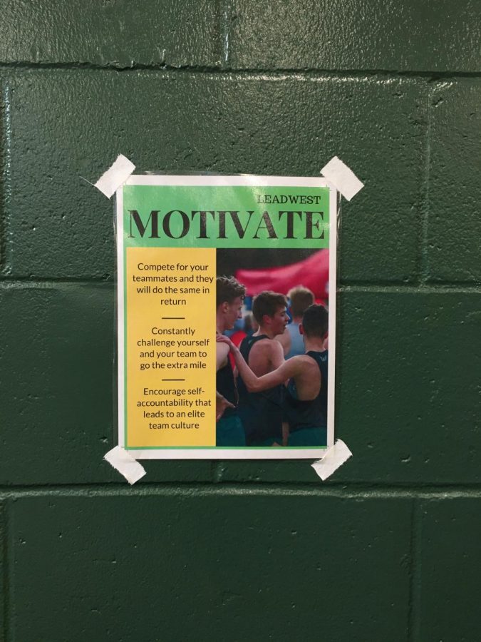 One of five Lead West posters is displayed above the free weights in the West High weight room. Each poster focuses on one of Lead Wests five core values.