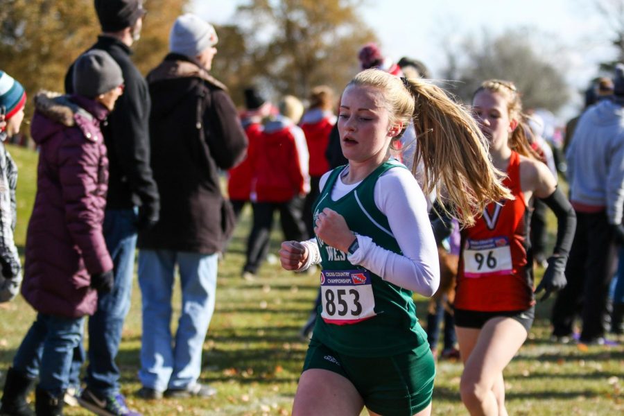 Camden Zirker '22 keeps her pace at the one mile marker during the state cross country meet on Nov. 2 in Fort Dodge.