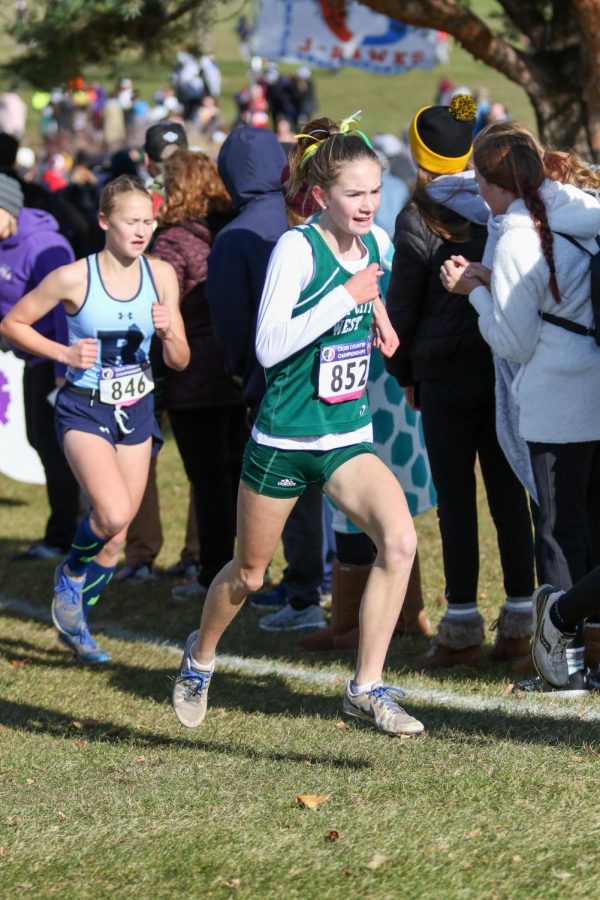 Annie Schwartz '23 stays close to teammate Camden Zirker '22 during the state cross country meet on Nov. 2 in Fort Dodge.