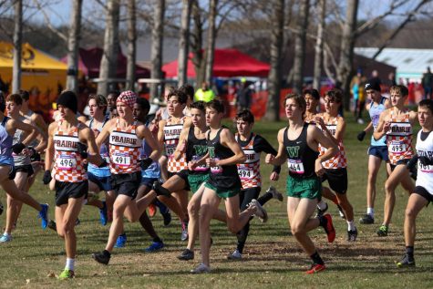 Nicolo Schianchi 22, Alex McKane 22, and Caden Noeller 22 sprint off the start line during the state cross country meet on Nov. 2 in Fort Dodge.