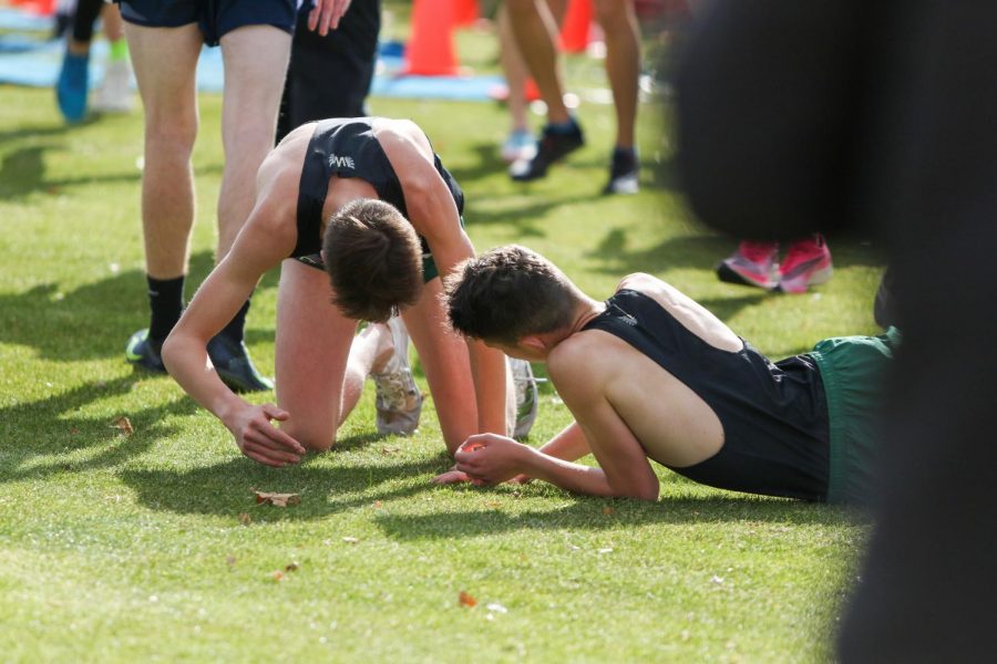 Nicolo Schianchi '22 and Alex McKane '22 catch their breath after a hard fought race at the state cross country meet on Nov. 2 in Fort Dodge. Both McKane and Schianchi are promising young members of the Lead West club.