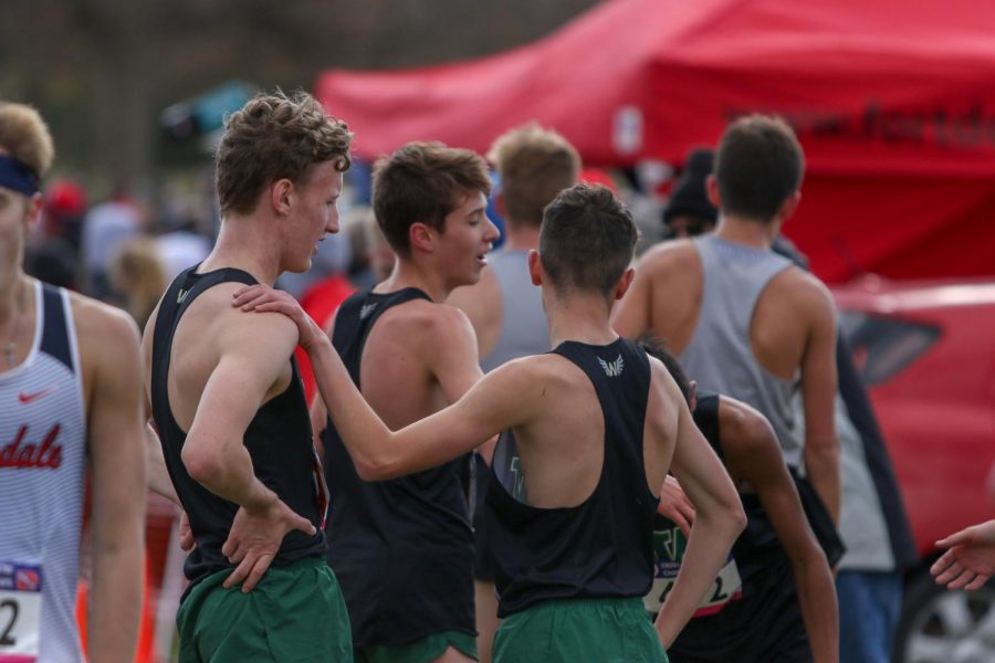 Teammates congratulate each other after the race at the state cross country meet on Nov. 2 in Fort Dodge.