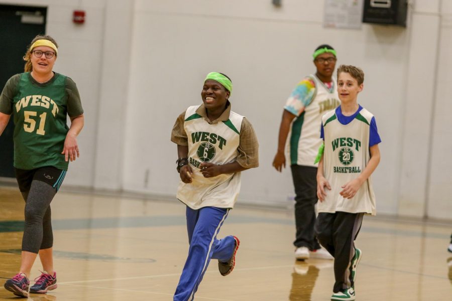 Byamungu Omari '20 runs back on defense after scoring the first points of the game at the third annual Best Buddies and PALS basketball game against faculty on Nov. 7.