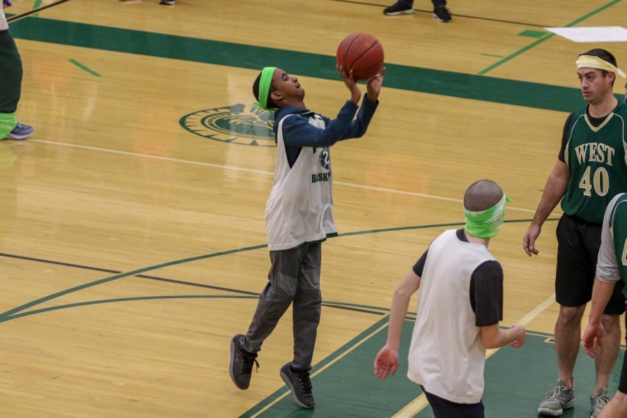 Basel Noureldin '23 makes a shot during the third annual Best Buddies and PALS basketball game against faculty on Nov. 7.