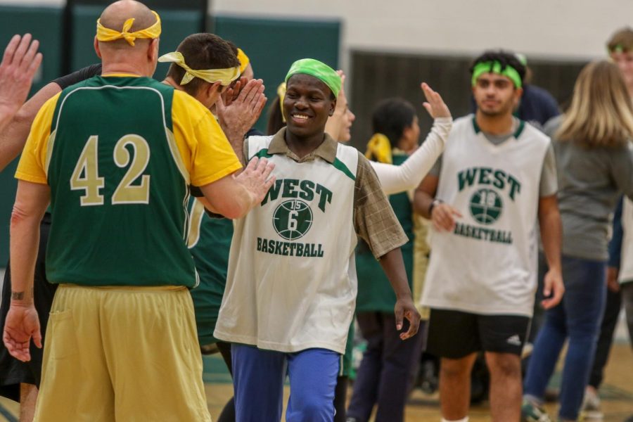 Byamungu Omari 20 high fives the faculty after the third annual Best Buddies and PALS basketball game against faculty on Nov. 7.