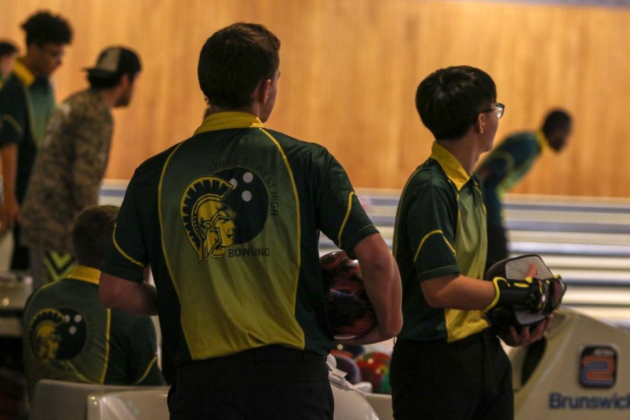 Ryan Bys '22 and David Jang '22 look up to check their scores on Nov. 26 at Colonial Lanes against City High.