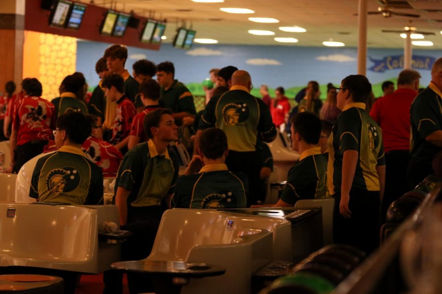 Varsity bowlers gather and rest between individual and baker rounds on Nov. 26 at Colonial Lanes against City High.