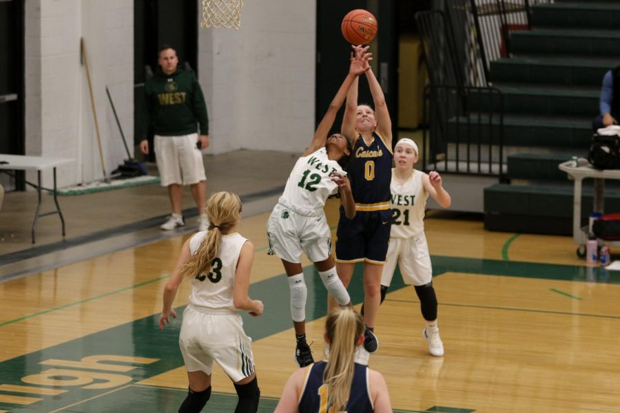 Meena Tate '23 reaches for a rebound against a Cascade defender on Nov. 22.