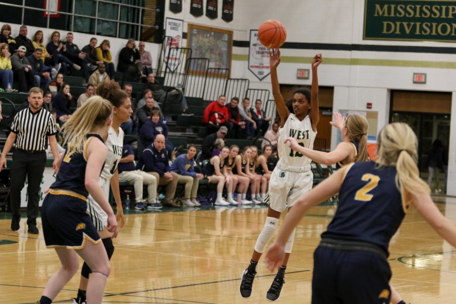 Freshman point guard Meena Tate pulls up for a jumper during the second quarter against Cascade on Nov. 22. Tate finished with 12 points, seven rebounds and three assists.