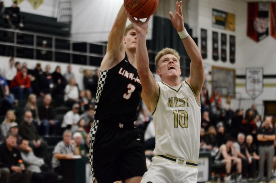 Tate Crane '20 drives to the hoop attempting a layup against Linn-Mar on Dec. 20. 