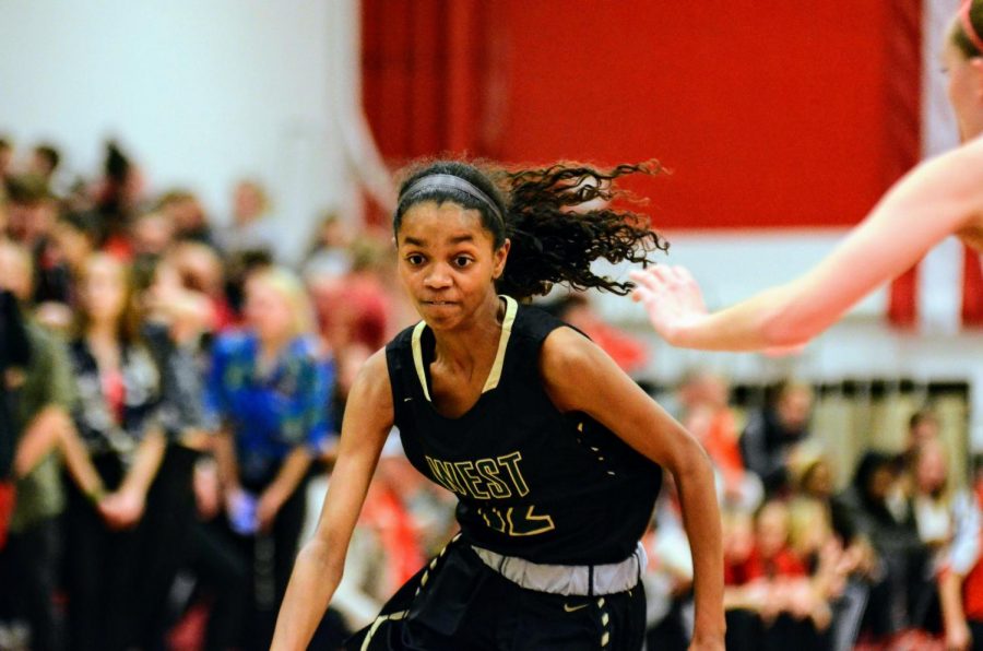 Meena Tate '23 drives to the hoop against City on Dec. 14.