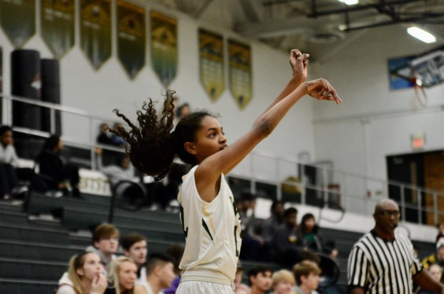 Meena Tate ‘23 takes a three point shot against Linn-Mar on Dec. 20.