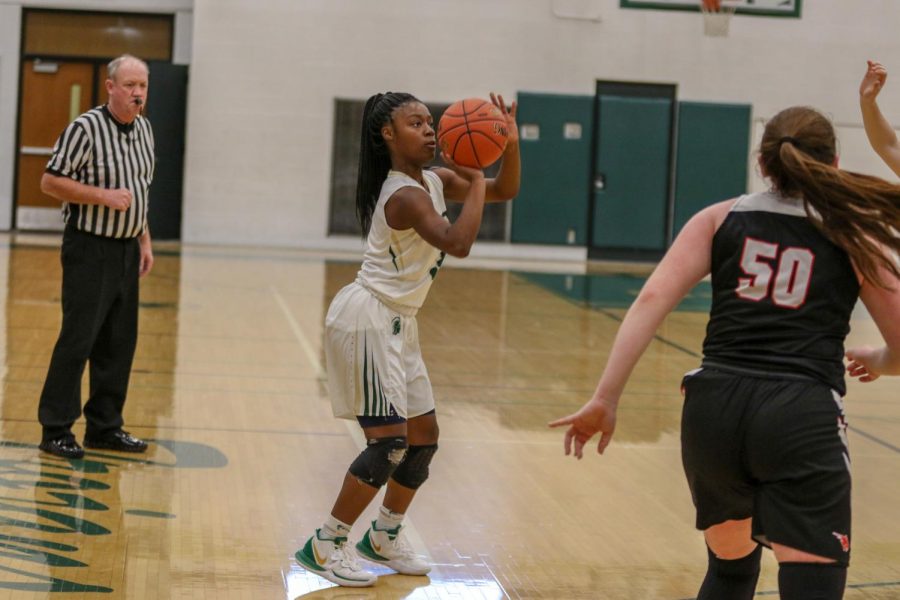 Matayia Tellis '21 squares up to shoot a three against Western Dubuque.