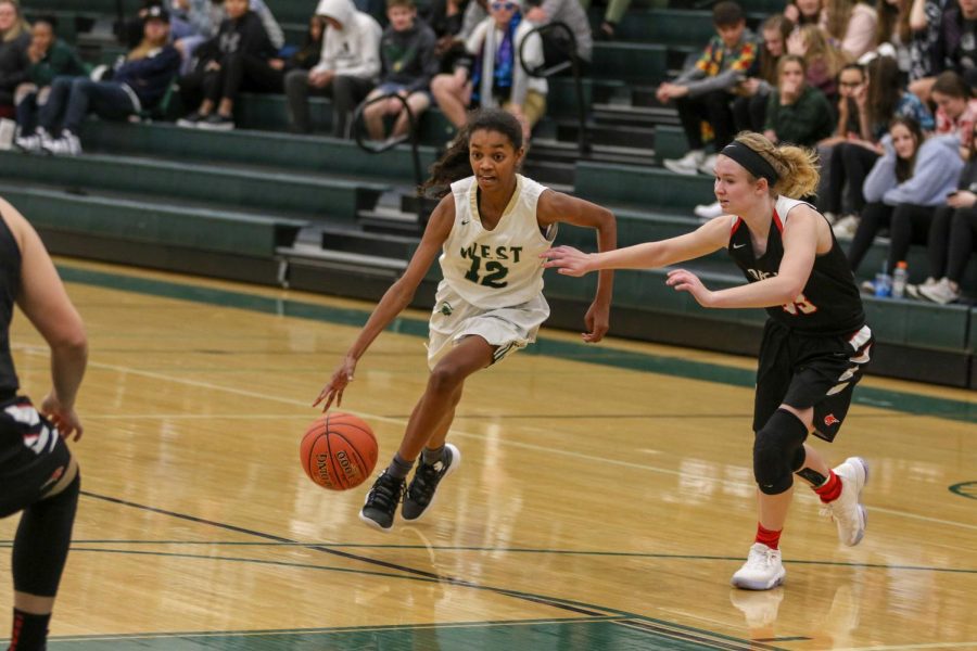 Meena Tate '23 drive to the hoop against Western Dubuque.