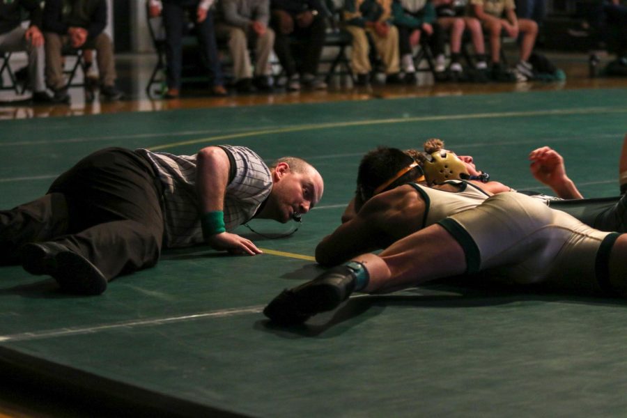 Hunter Garvin ‘22 attempts to pin his opponent during the team's home meet against Dubuque Hempstead on Dec. 12.