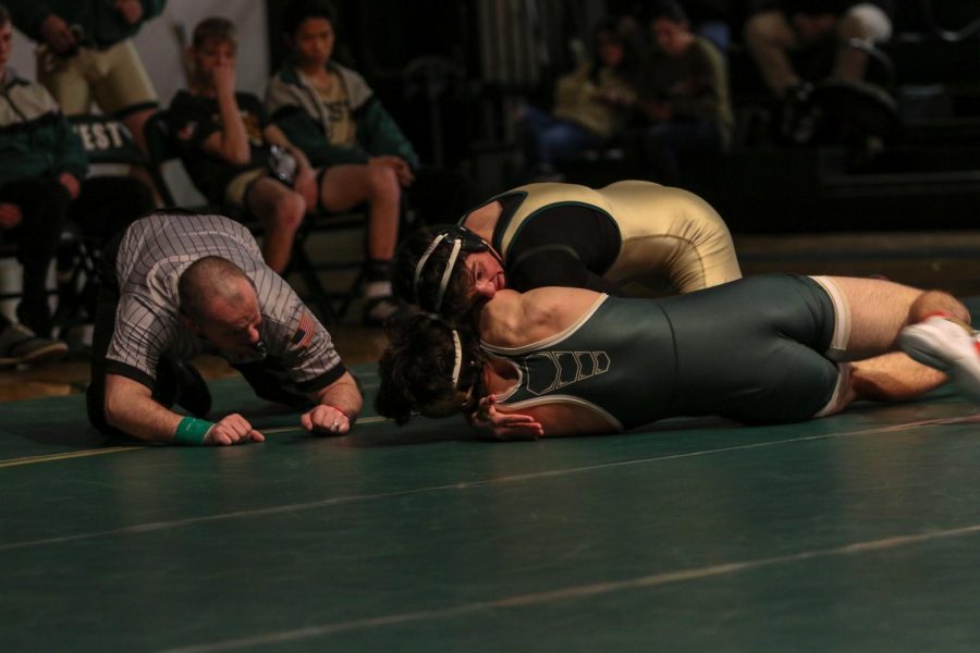 Ashton Barker 21 tries to turn his opponent during his match at 182 pounds. Barker pinned Hempsteads Andrew Hefel 20 in 1:08.