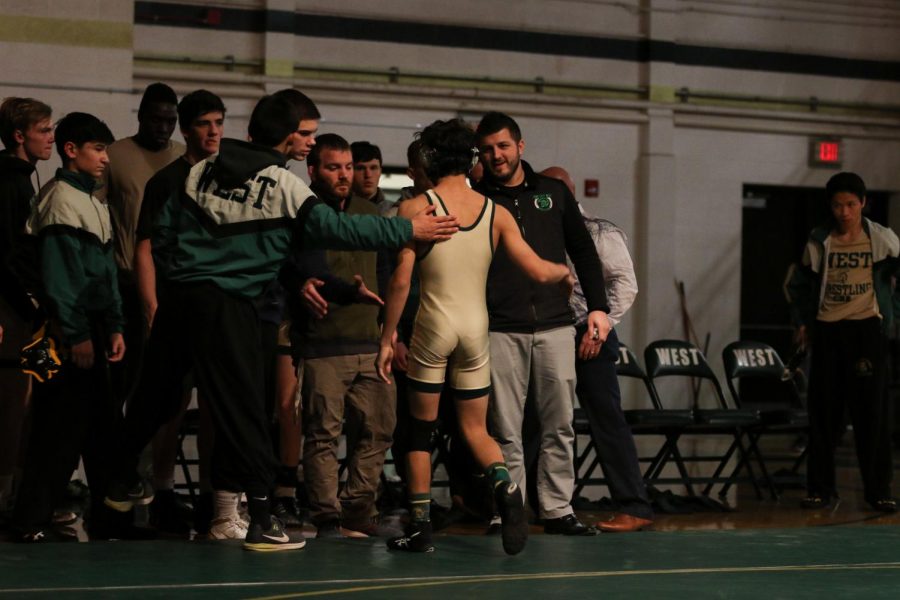 The team congratulates Thomas Pierce '22 after his pin against Landon Reisen '23 to set the score at 44-24 Hempstead.