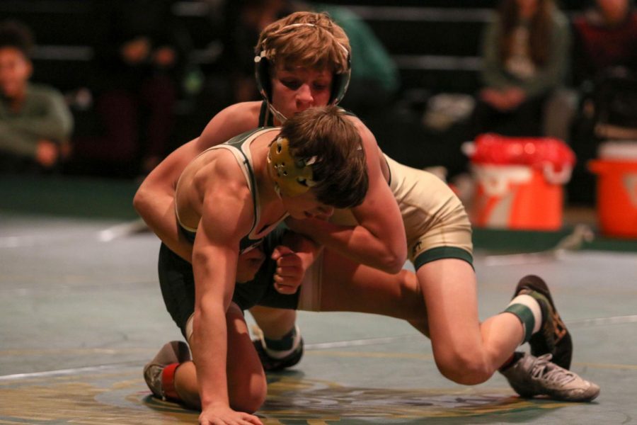 Grant O'Dell '22 rides his opponent on the mat during the 106 pound match against Dubuque Hempstead on Dec. 12. O'Dell pinned Hempstead's Joey Horch '22 in 58 seconds.