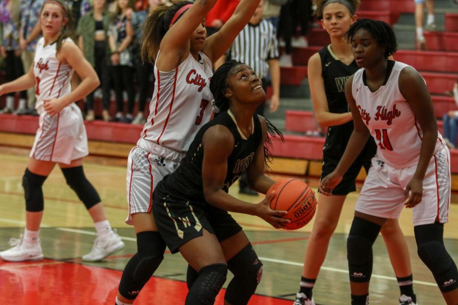 Matayia Tellis '21 looks to shoot under the hoop against City on Dec. 14.