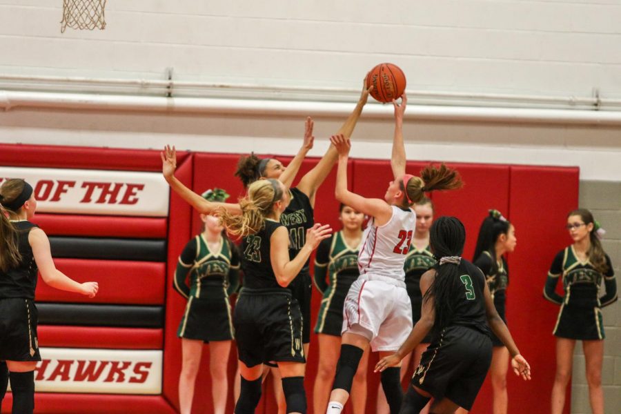 Liv Williams '21 blocks City High's Aubrey Joens '20 on Dec. 14.