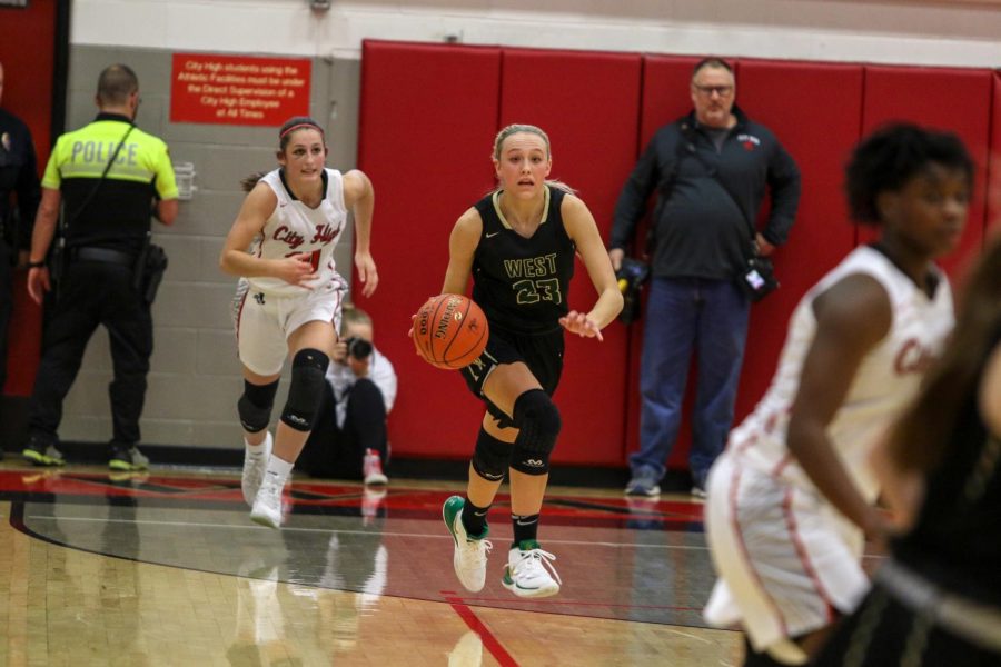 Audrey Koch '21 looks to pass as she pushes the ball up the court against City on Dec. 14. 