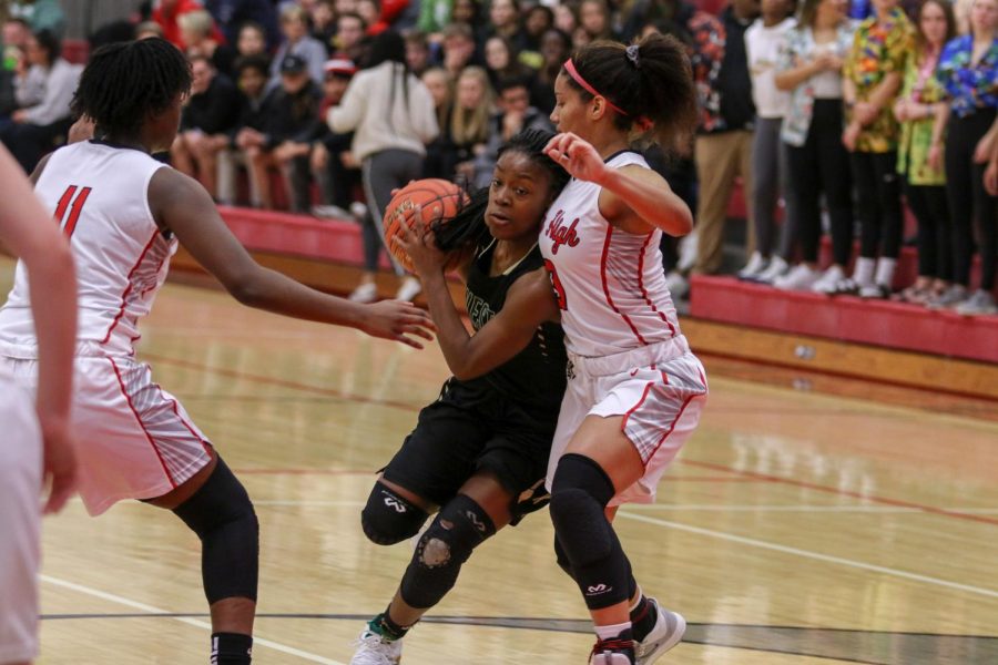 Matayia Tellis '21 drives into the lane against City on Dec. 14.