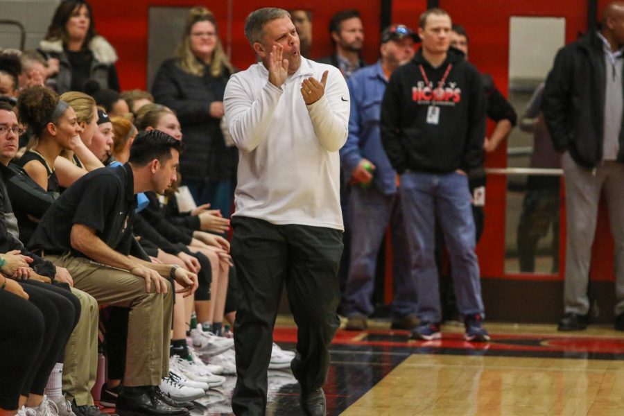 Head coach Bj Mayer cheers on his team against City on Dec. 14.