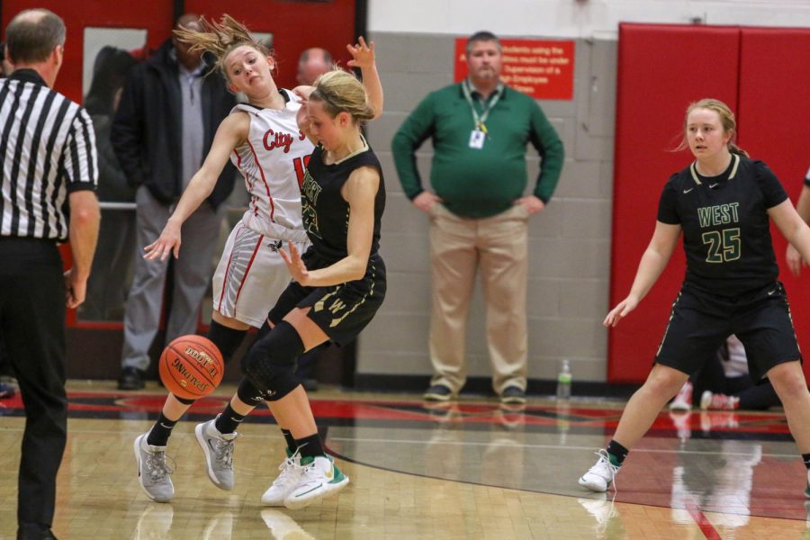 Audrey Koch '21 collides with City High's Kelsey Joens '23 on defense against City on Dec. 14.