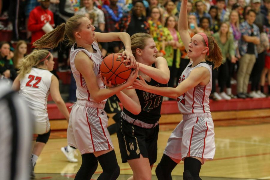 Anna Prouty '23 fights for a jump ball against City on Dec. 14.