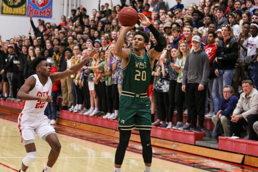 Marcus Morgan '21 knocks down a three against City on Dec. 14.