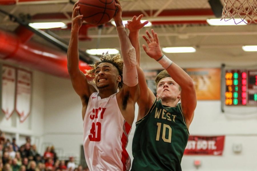 Tate Crane '20 fights for a rebound over City High's Jamari Newson '22 on Dec. 14.