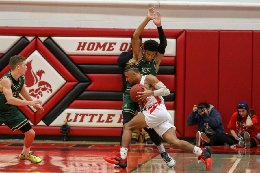 Marcus Morgan '21 takes a charge against City on Dec. 14.