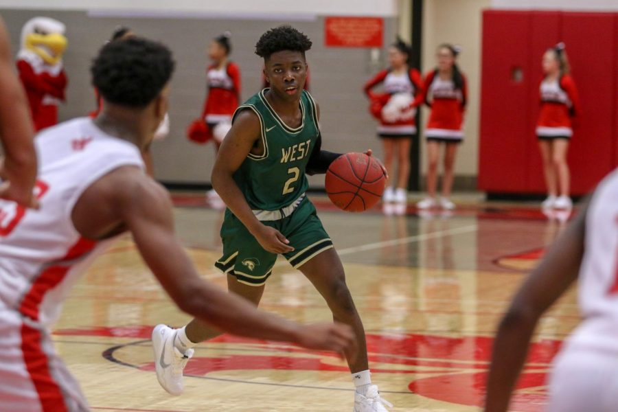 Christian Barnes '22 brings the ball up the court against City on Dec. 14.