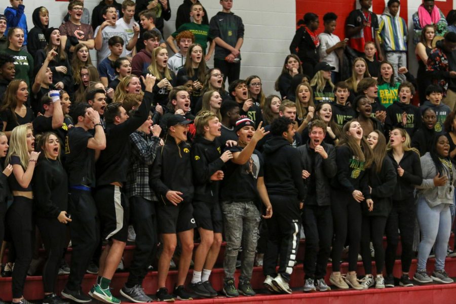 The student section celebrates the boys' basketball team's win over City on Dec. 14.