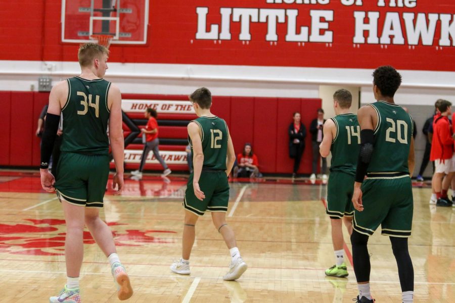 Even Brauns '20, Joe Goodman '20, Nick Pepin '20, and Marcus Morgan '21 walk onto the court at the start of the fourth quarter against City on De. 14.