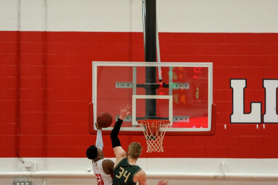 Even Brauns '20 blocks City High's  Keshawn Christian '20 to end the game on Dec. 14.