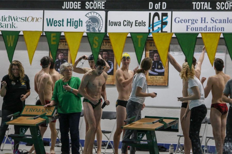 Body Skelley '22 celebrates his relay team's win during a dual swim meet against Linn-Mar on Dec. 17.