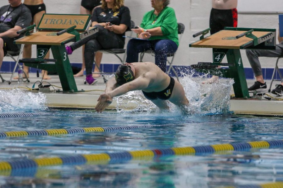 James Pinter '20 flys off the blocks during a dual swim meet against Linn-Mar on Dec. 17.