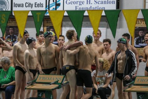 Jordan Christensen 22 is congratulated by his teammates after breaking the 100-yard breaststroke school record in a time of 58.97 seconds during a dual swim meet against Linn-Mar on Dec. 17.