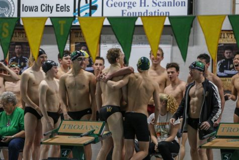 Jordan Christensen '22 is congratulated by his teammates after breaking the 100-yard breaststroke school record in a time of 58.97 seconds during a dual swim meet against Linn-Mar on Dec. 17.