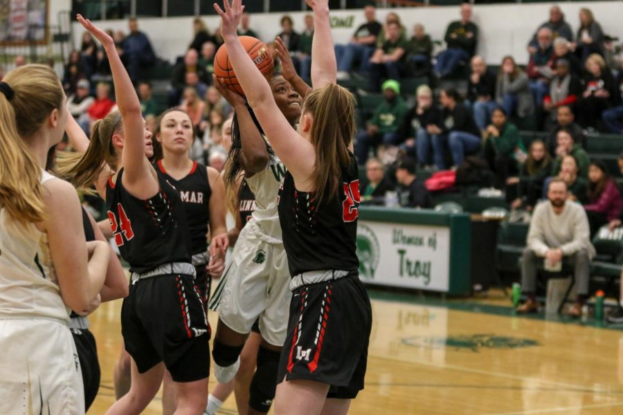 Matayia Tellis '21 puts up a shot surrounded by Linn-Mar defenders on Dec. 20.