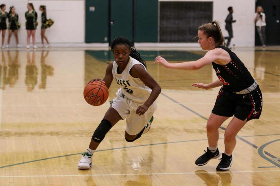 Matayia Tellis '21 drives to the hoop against Linn-Mar on Dec. 20.