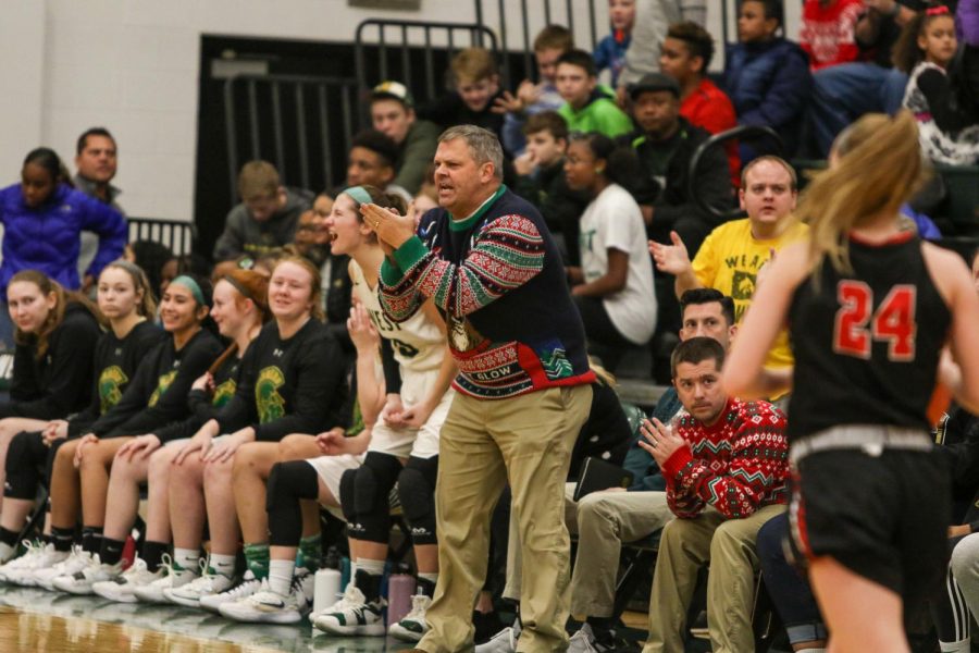 Head coach Bj Mayer celebrates a bucket against Linn-Mar on Dec. 20.